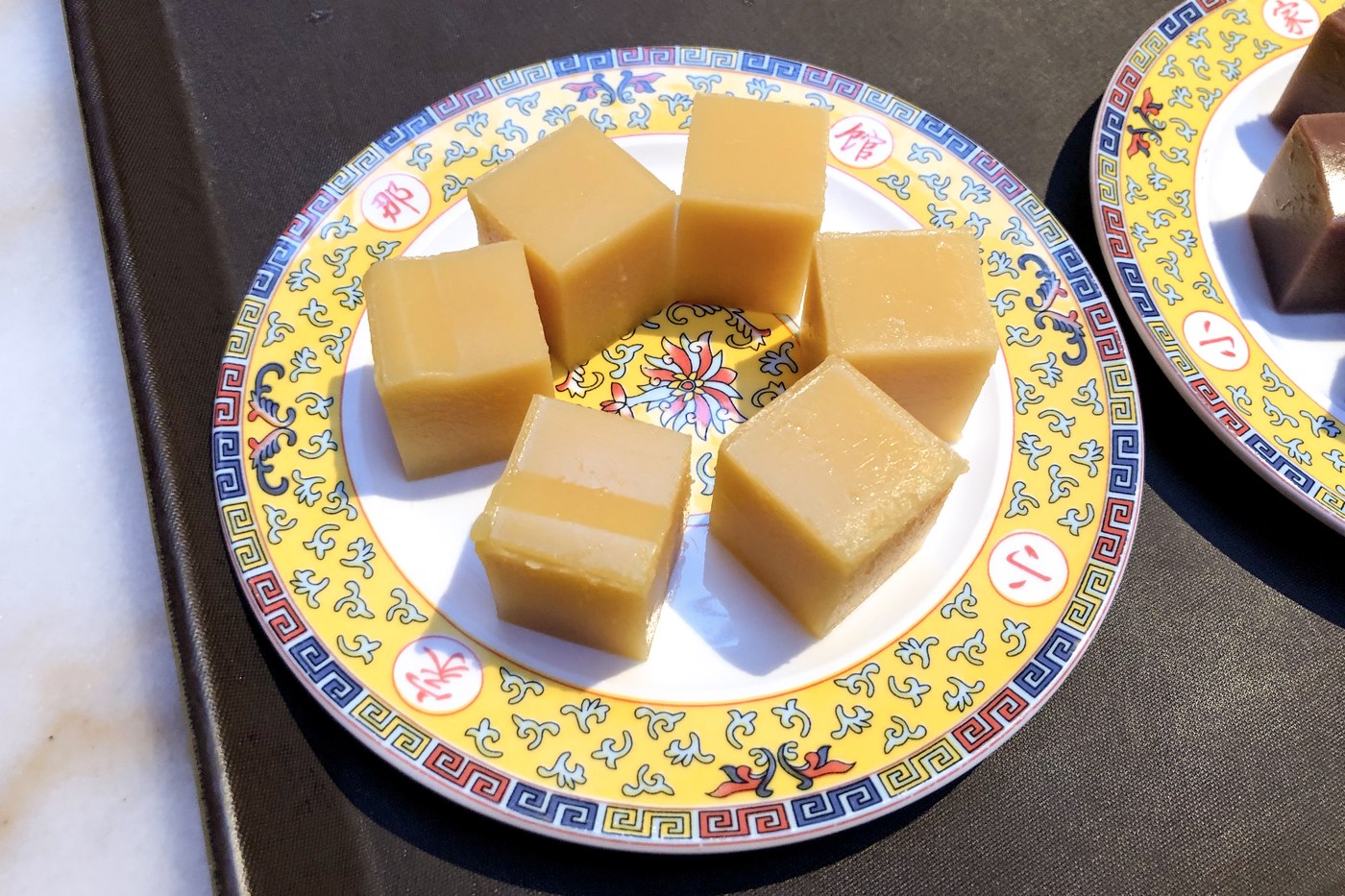 Yellow pea cakes served on a patterned plate